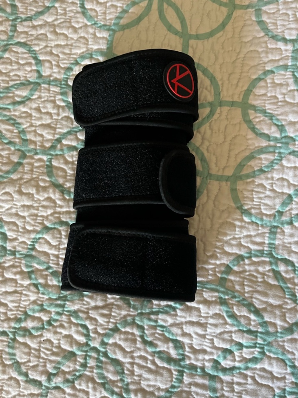 Black Velcro Support Knee Brace with Red Circular Logo
